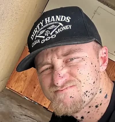 Ryan Nunez in a work cap, partway through a drain job