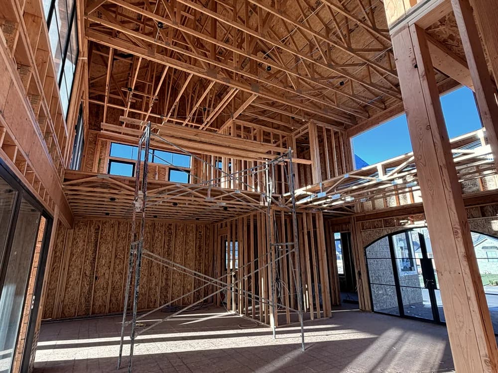 New framing inside a house with scaffolding